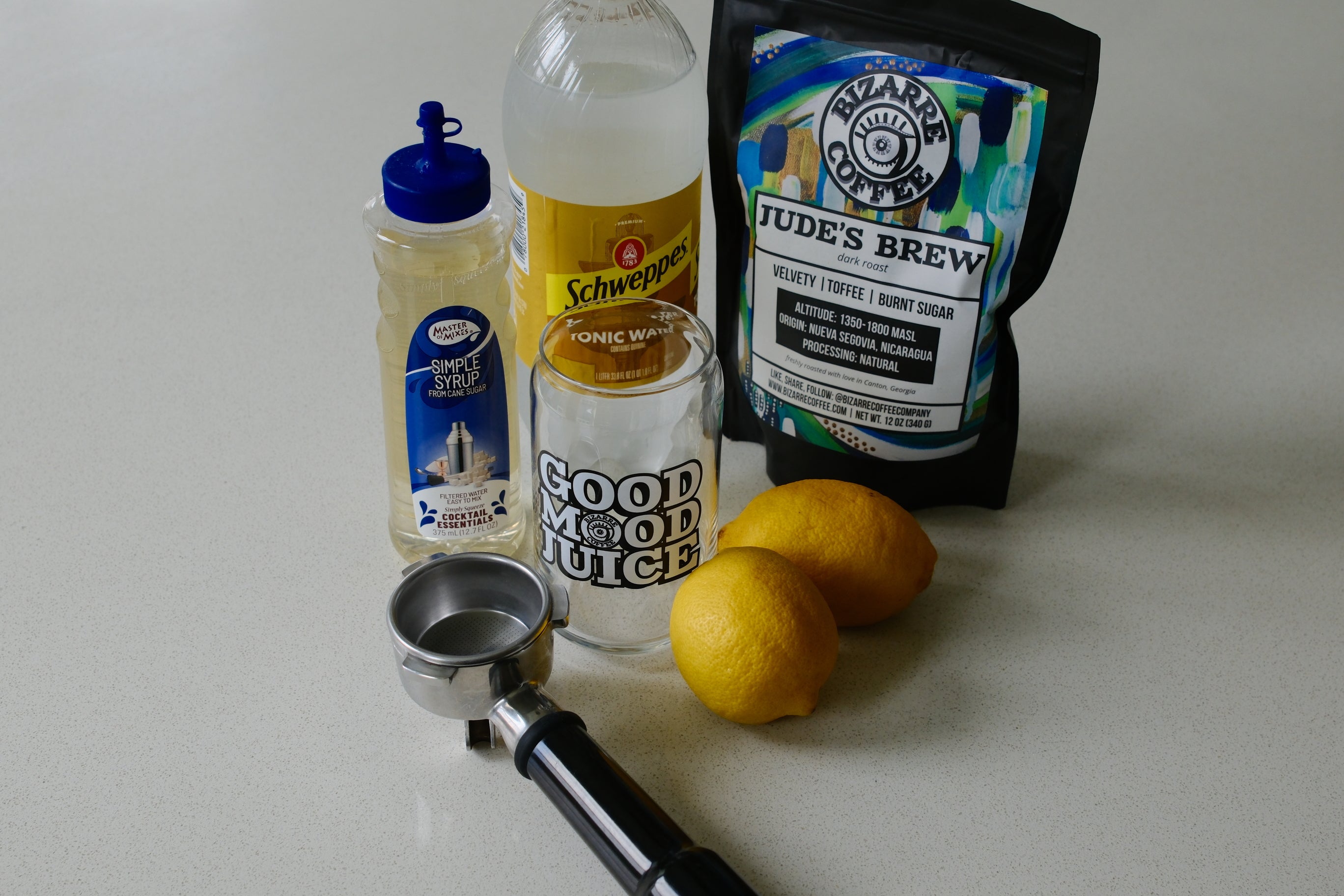 Lemons, a glass, coffee bag and tonic water.