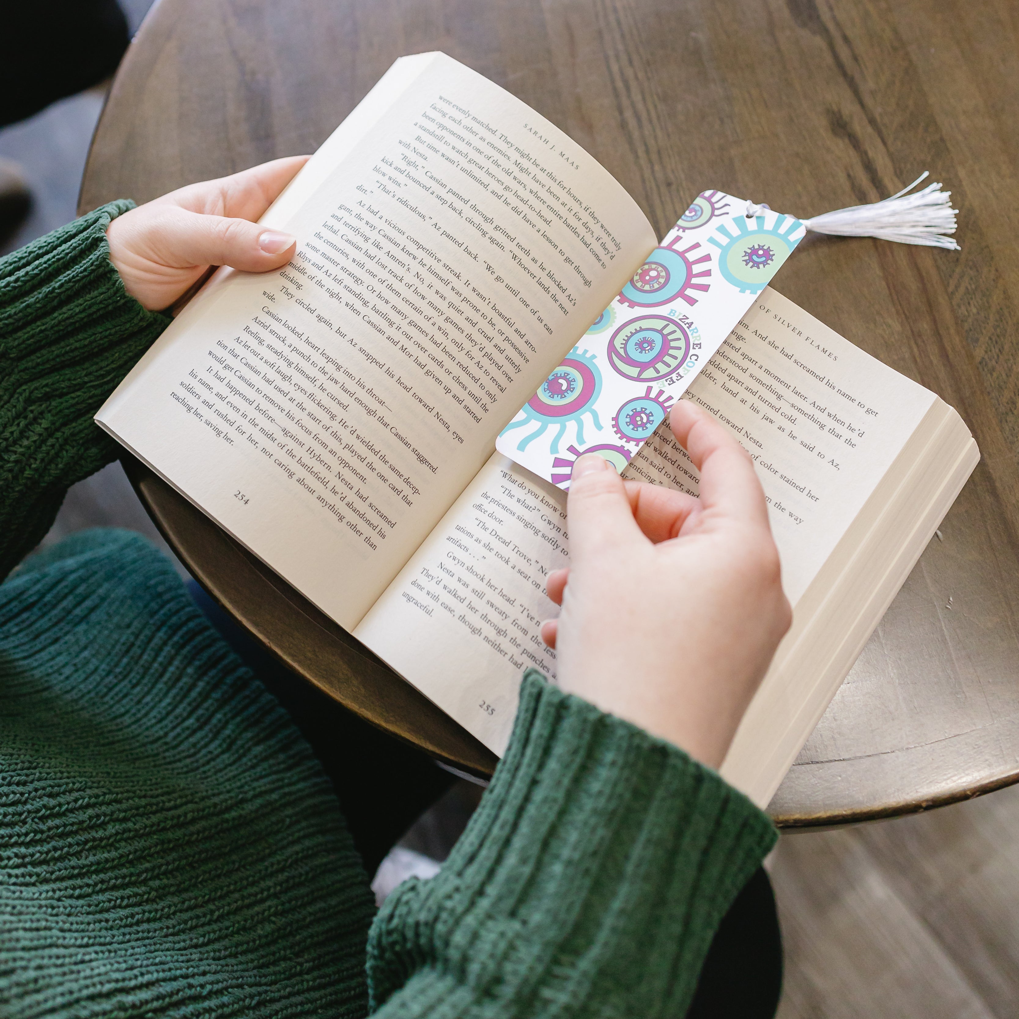 A Bizarre eye design bookmark sitting in an open book.