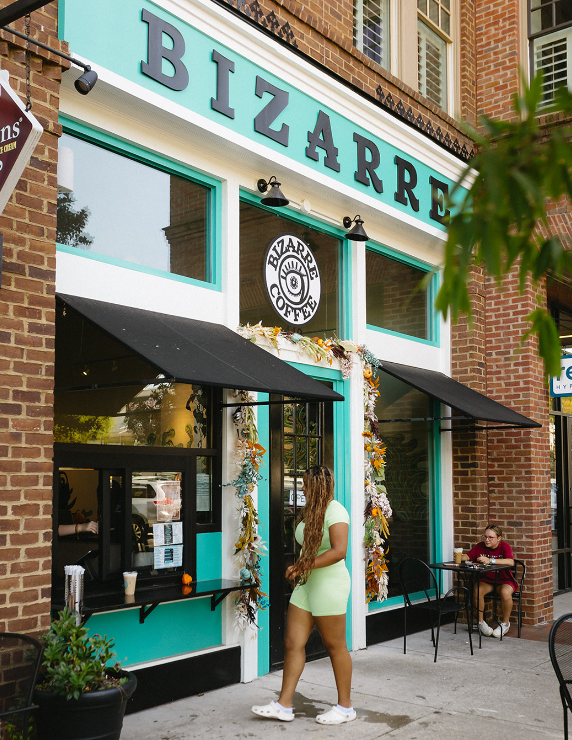 Bizarre Coffee shop exterior with a person walking by