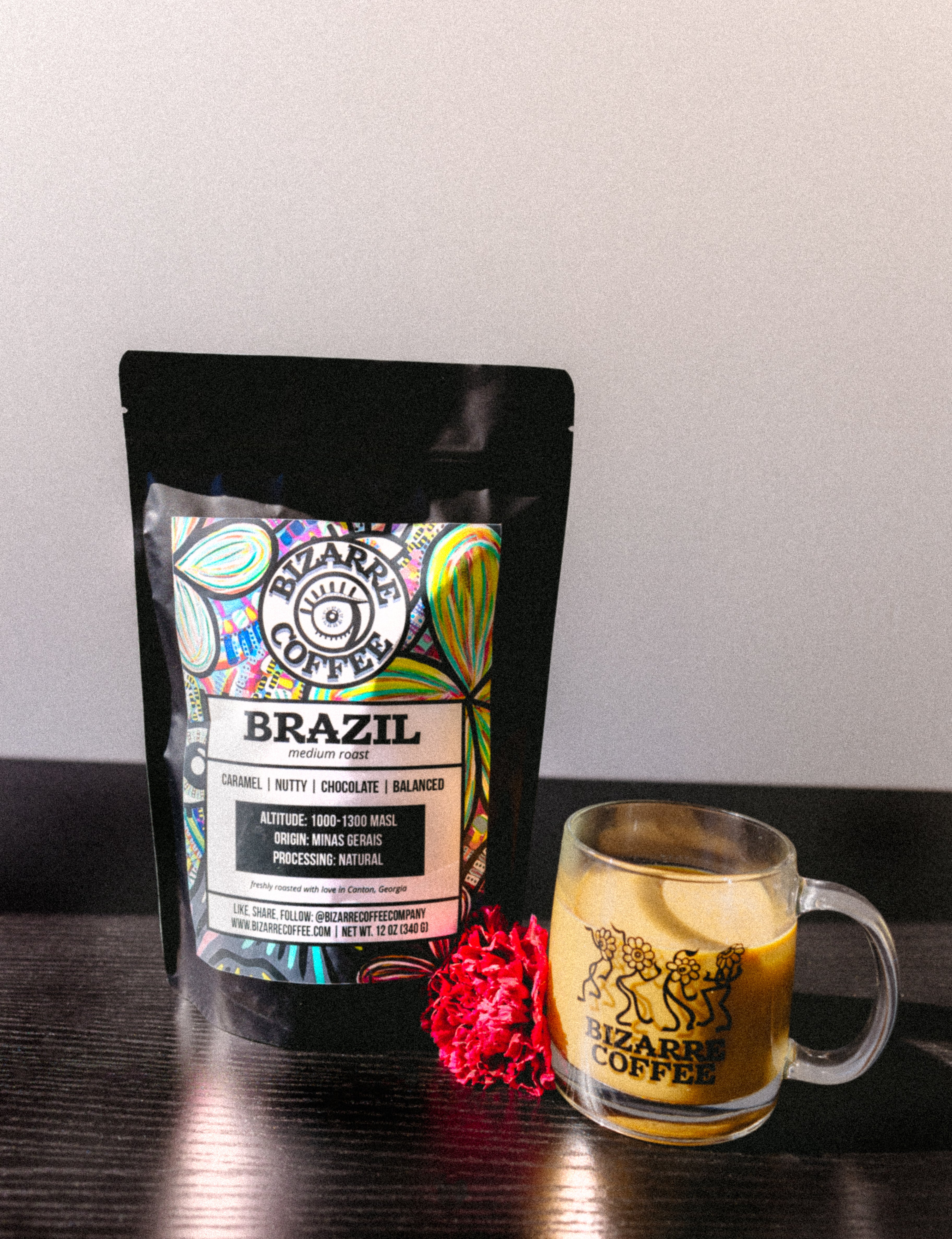 A bag of Brazil medium roast coffee next to a coffee mug.