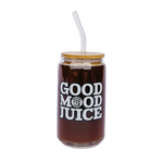 A glass cup that says Good Mood Juice and has a bamboo lid with a glass straw.