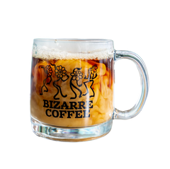 A glass mug that says Bizarre Coffee and displays dancing flowers in black.