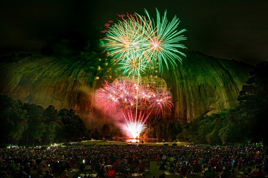 Fireworks over a stone mountain.