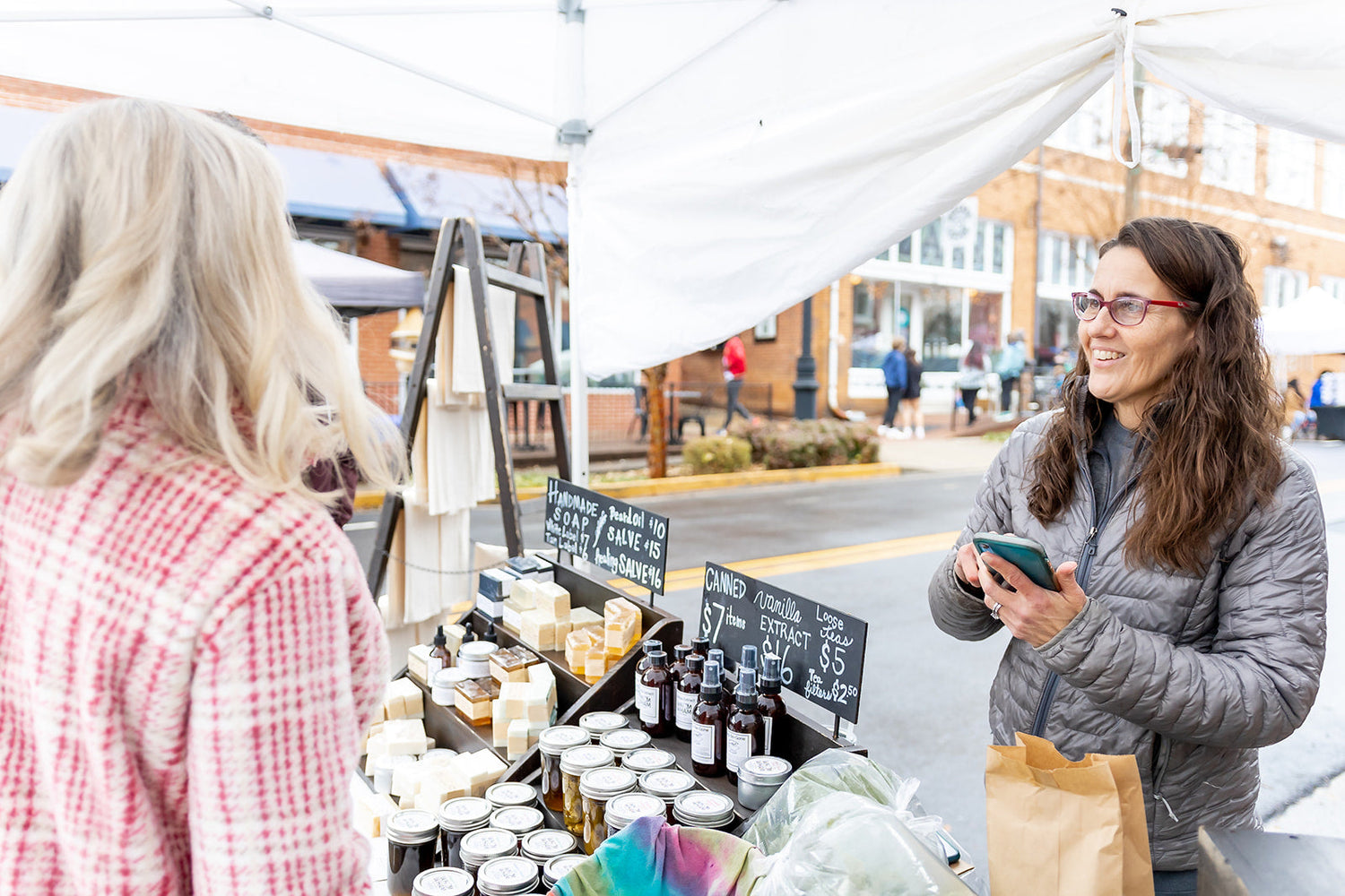 A woman shopping at a farmers market.