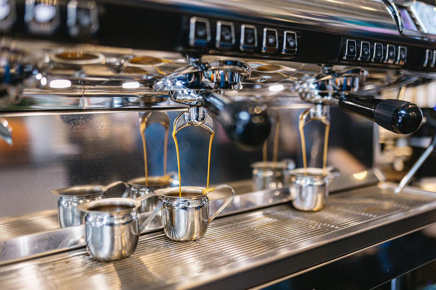 An Espresso Machine with two shots of espresso being poured. 
