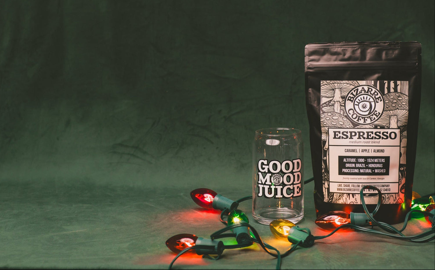 Espresso bag and glass with 'Good Mood Juice' on a green background