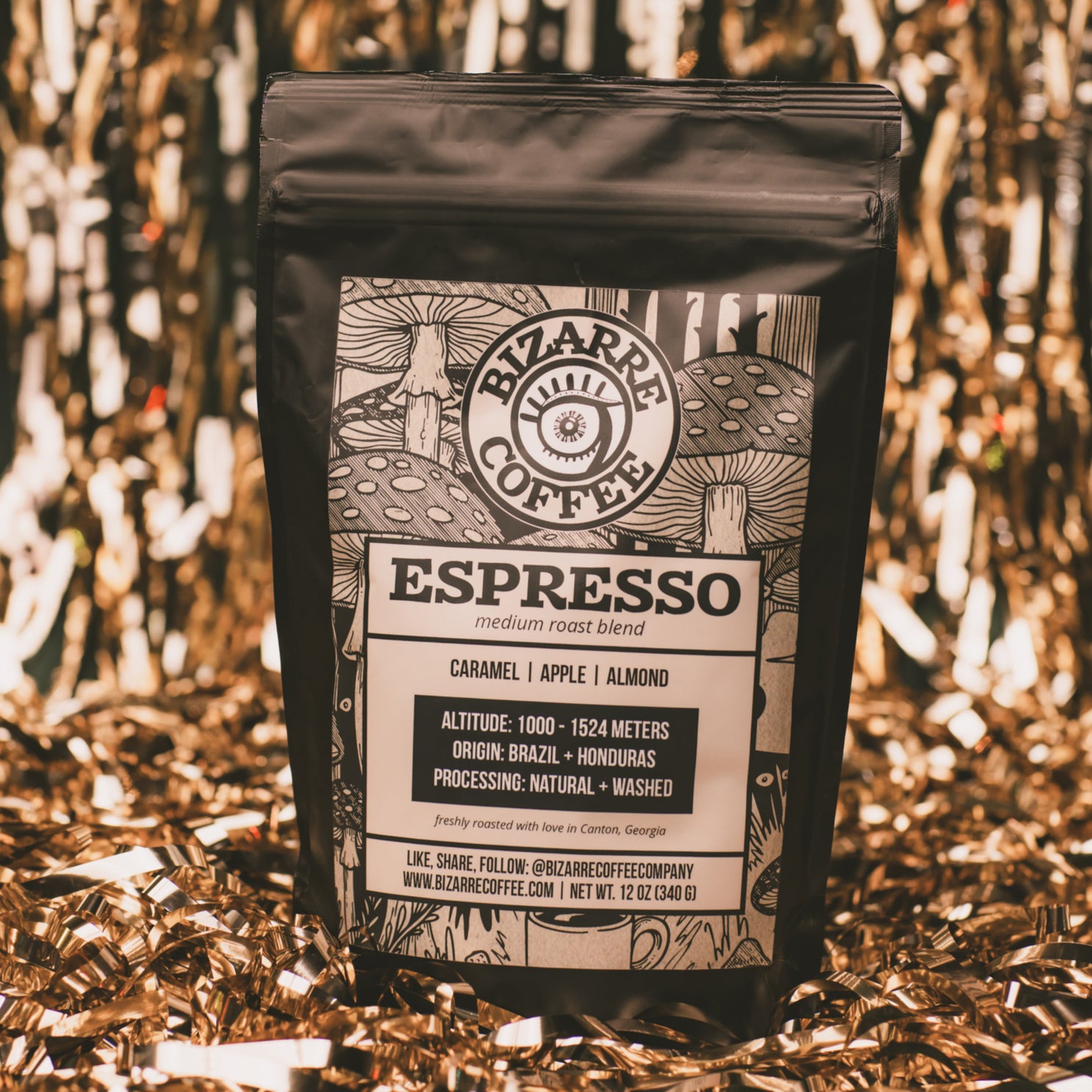 A bag of Espresso Medium Roast Blend with gold tinsel in the background.