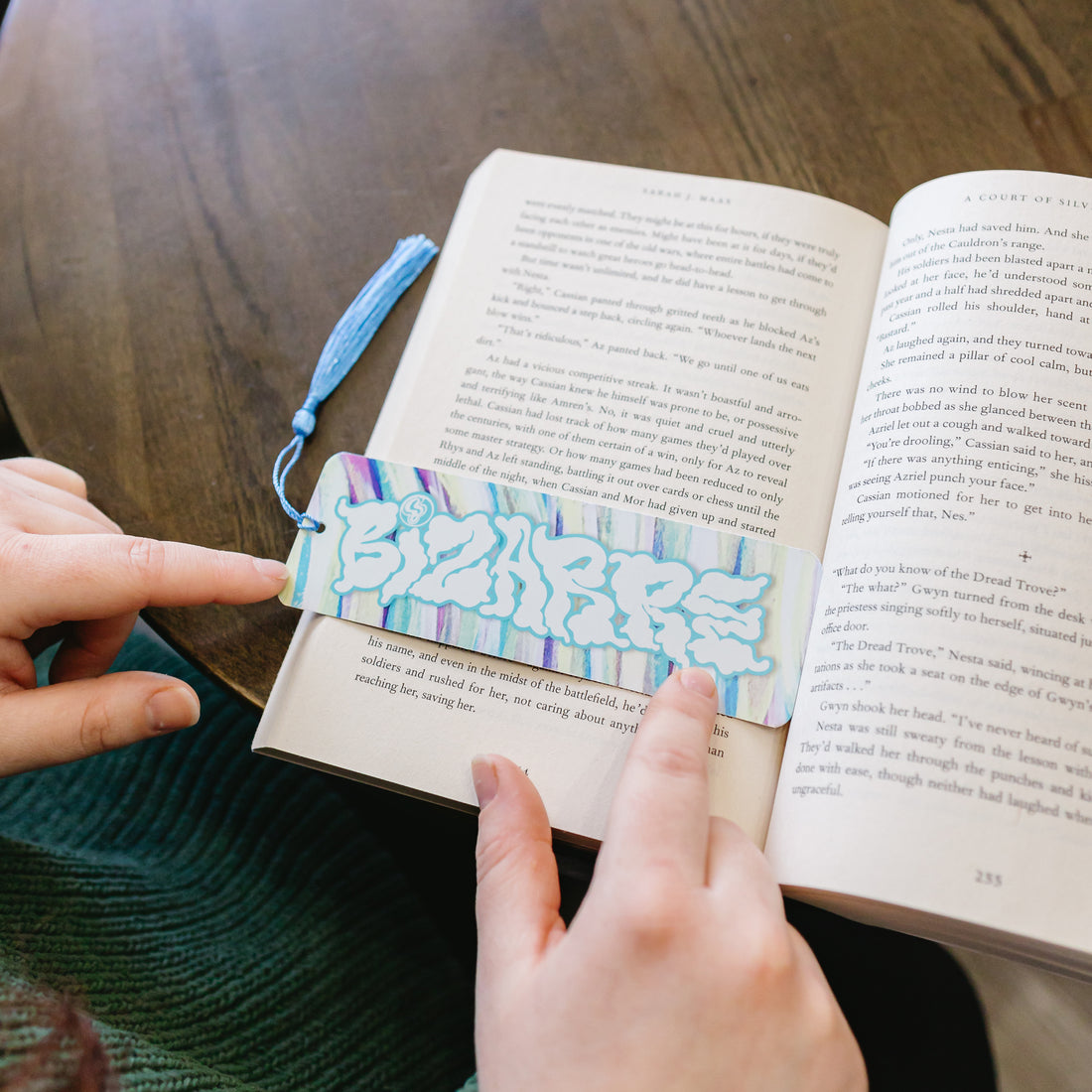 A Bizarre bookmark resting on an open book.
