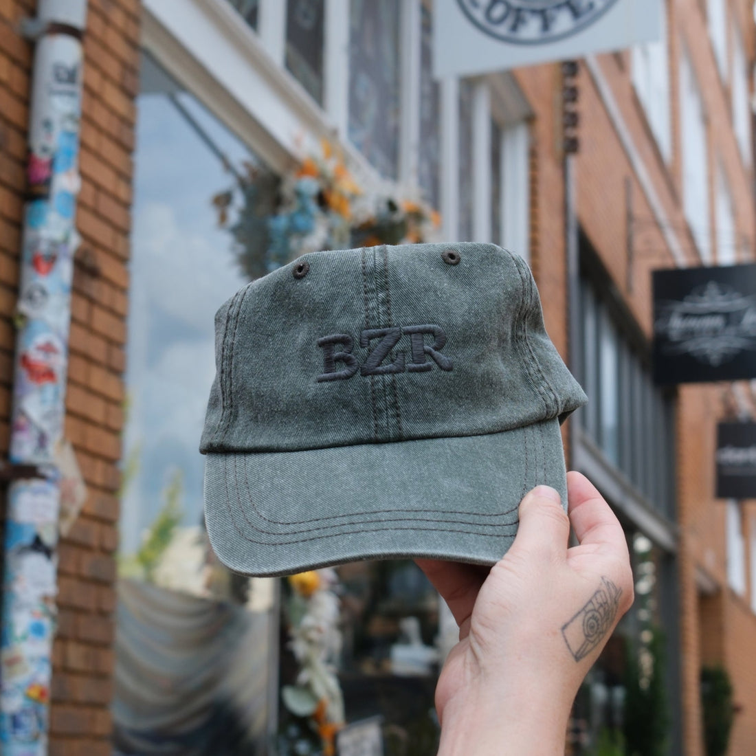 Person holding a cap with &