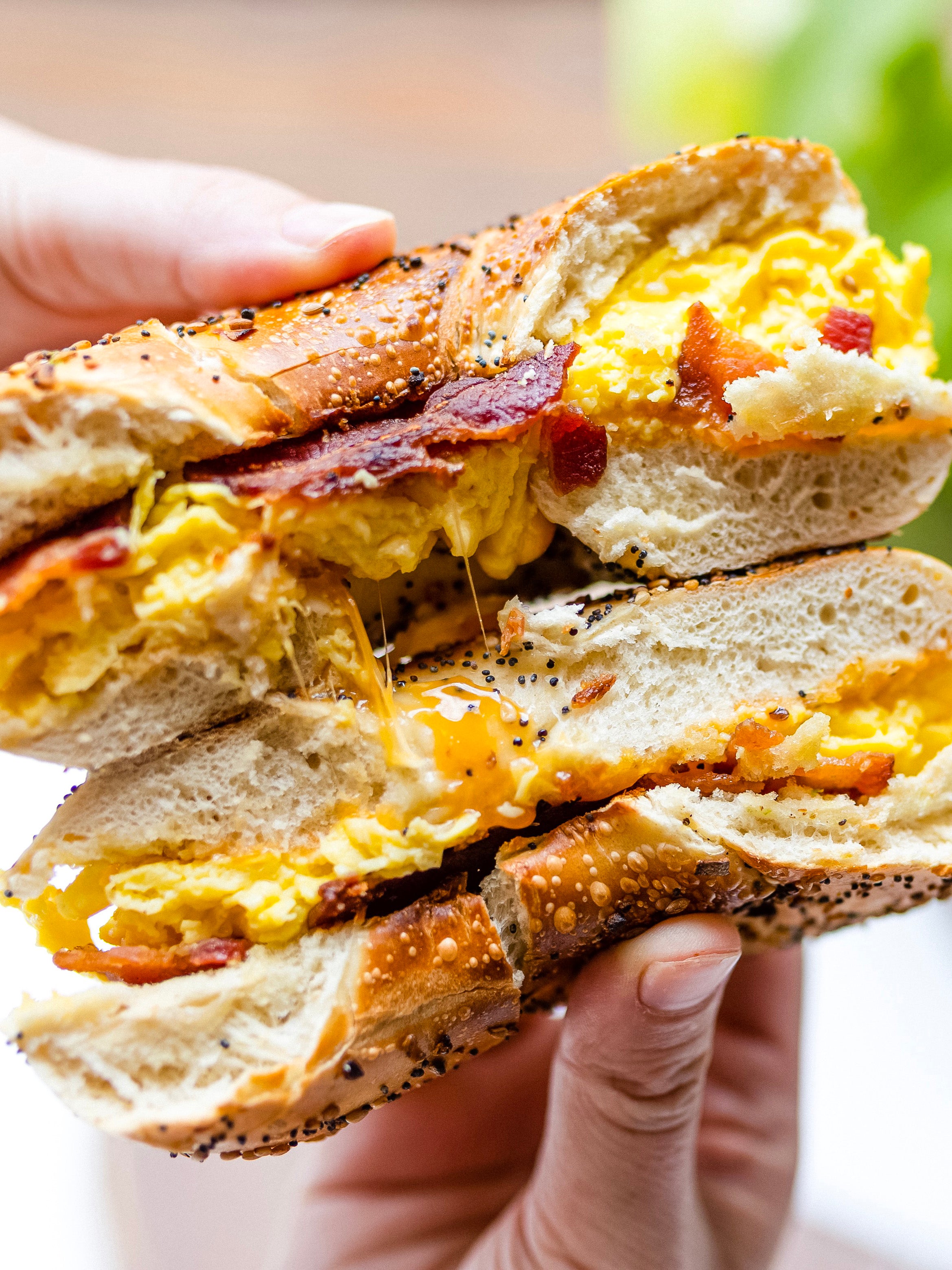 A breakfast bagel broken in half.